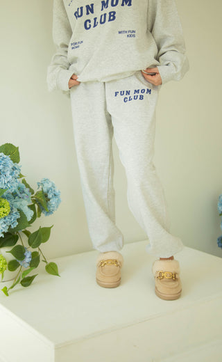 Person wearing a 'Fun Mom Club' sweatshirt and sweatpants matching set 