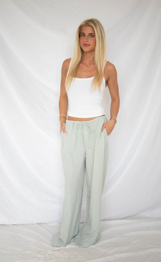 Women wearing green and white gingham pants. 