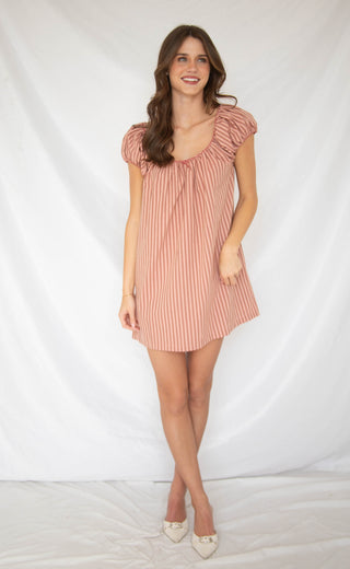 Women wearing mini pink stripe babydoll dress. 