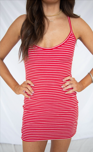 Red and white striped dress worn by a person on a white background